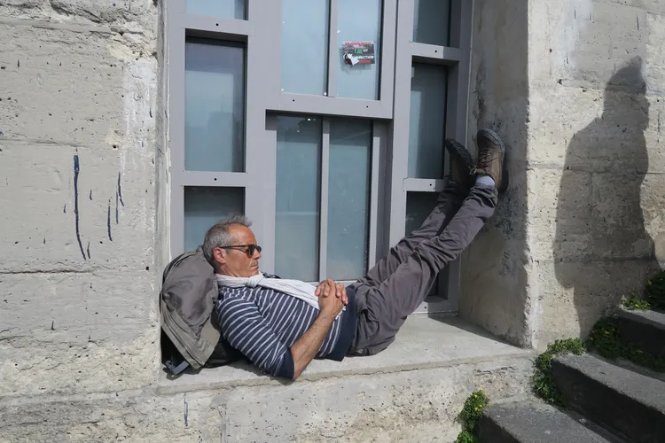 Man taking a nap in a cozy corner under the sun light of Seine River, Paris, 2019 Thumbnail